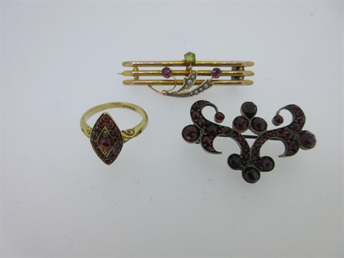Lot 66 - A garnet ring stamped '18ct' together with a garnet brooch and another