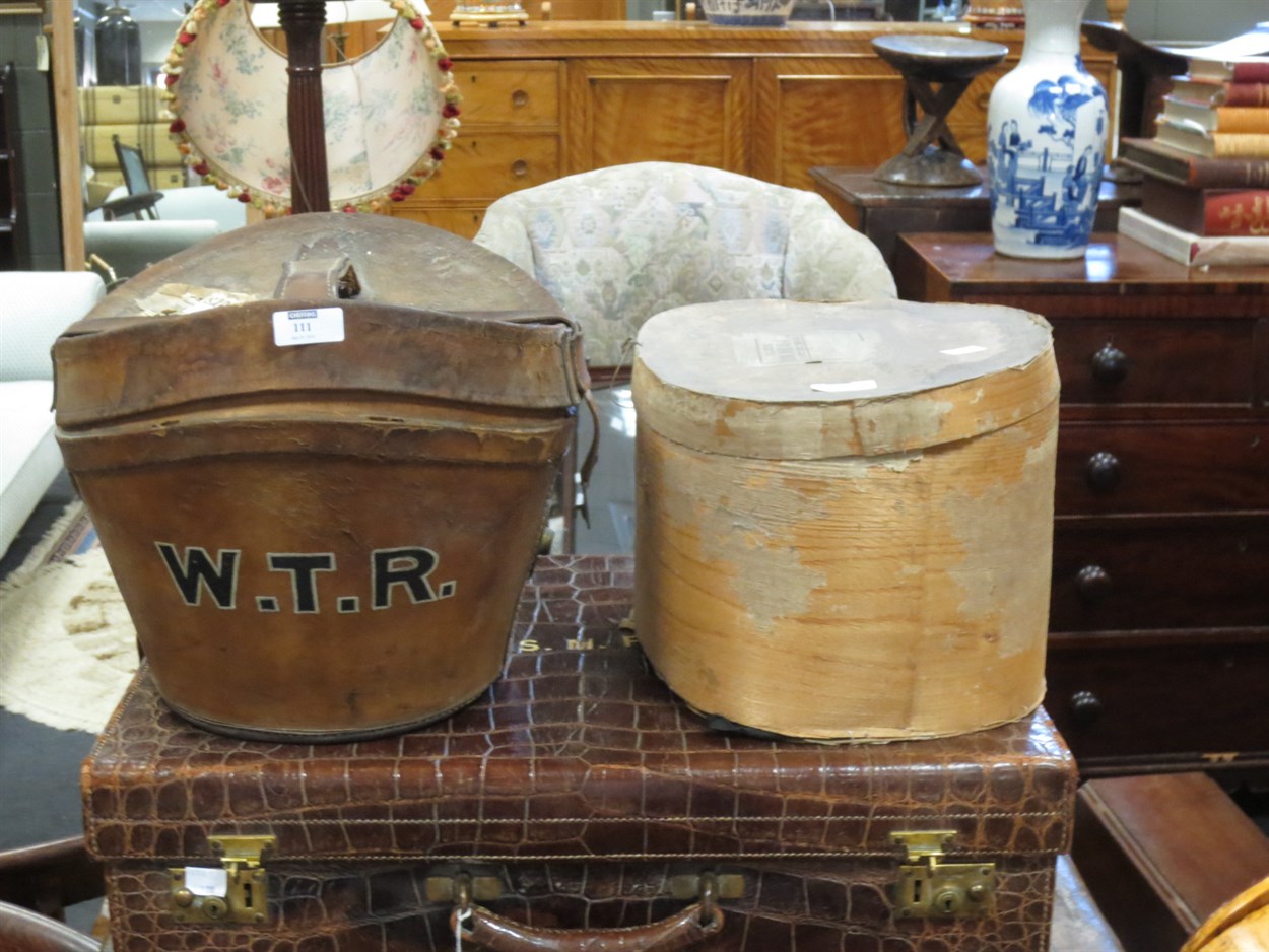 Lot 111 - A leather hat box with top hat, and a riding...