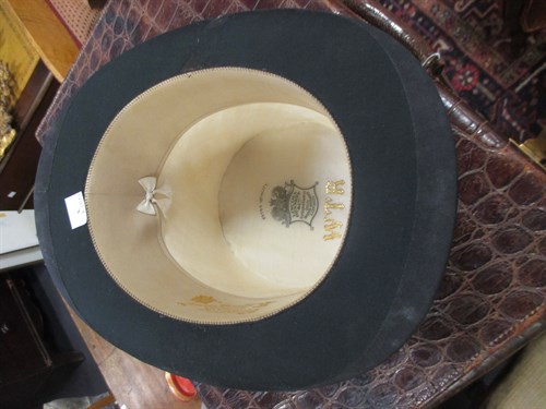 Lot 111 - A leather hat box with top hat, and a riding...
