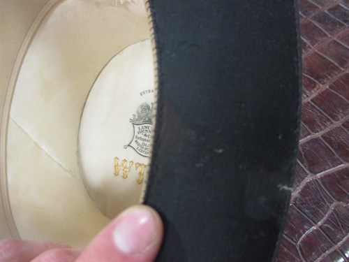 Lot 111 - A leather hat box with top hat, and a riding...