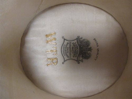 Lot 111 - A leather hat box with top hat, and a riding...