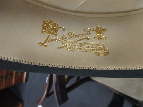 Lot 111 - A leather hat box with top hat, and a riding...
