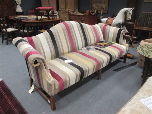 Lot 707 - A three seater sofa upholstered in a striped...