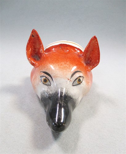 Lot 8 - A 19th century pottery fox head stirrup cup