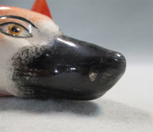 Lot 8 - A 19th century pottery fox head stirrup cup