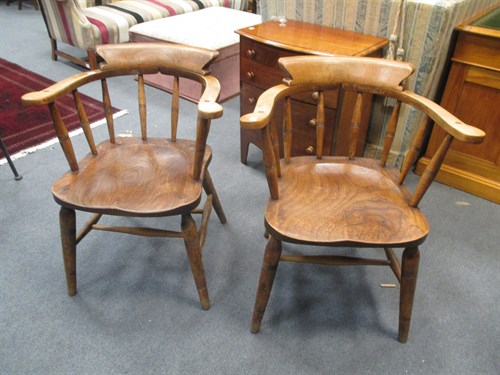 Lot 665 - A pair of beech and elm smokers bow armchairs...