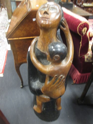 Lot 88 - A modern carved and ebonised teak group of the...