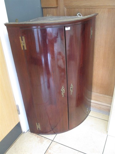 Lot 424 - A mid-18th century mahogany bow front hanging...
