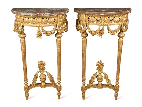 Lot 508 - A pair of 19th century Louis XVI style carved giltwood rouge marble top console tables (2)