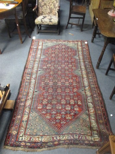 Lot 739 - A Caucasian red ground rug, 223 x 124cm