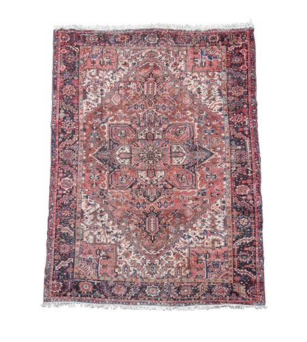 Lot 473 - A Heriz pink, ivory and blue ground carpet,...