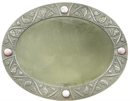 Lot 244 - An Arts & Crafts pewter oval bevelled wall mirror