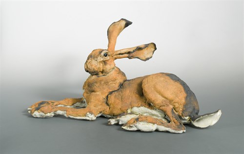 Lot 105 - Elaine Peto (Contemporary), a textured and part glazed studio pottery life-size model of a recumbent hare