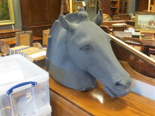 Lot 294 - A black painted plaster life-size model head...
