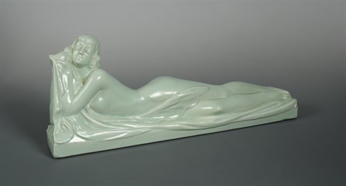 Lot 72 - Marines-France, an Art Deco pastel green glazed pottery figure of a recumbent female nude