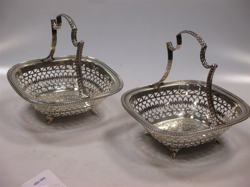 Lot 414 - A pair of George V silver fruit baskets, with...