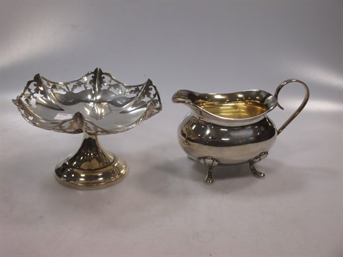 Lot 423 - A silver sauce boat and silver pierced bon-bon...