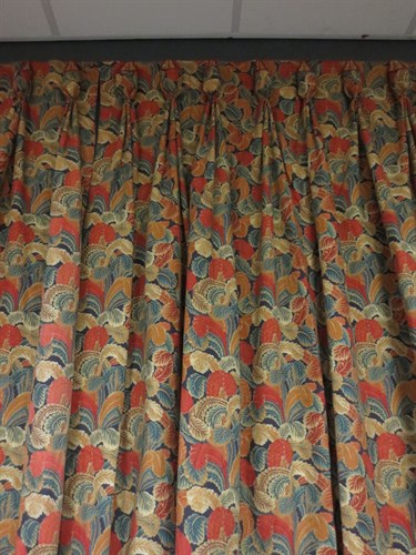 Lot 721 - A pair of lined orange patterned curtains,...