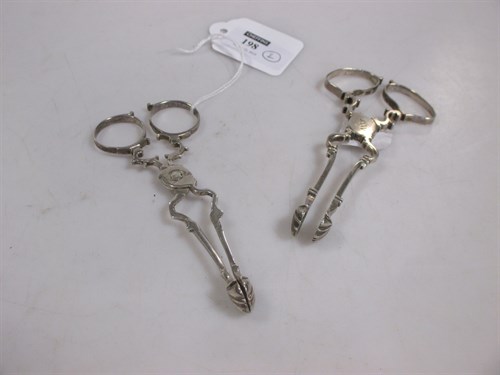 Lot 198 - Two pairs of Georgian silver scissor action...