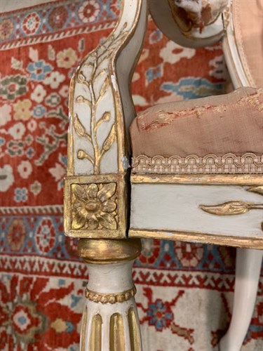 Lot 554 - A pair of George III painted and parcel gilt salon chairs