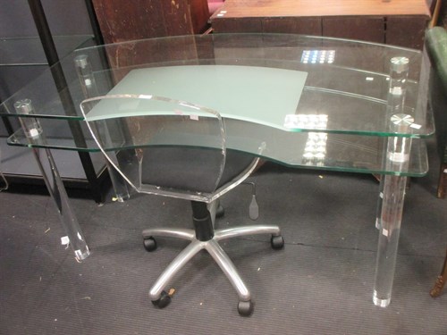 Lot 558 - A contemporary glass topped desk on acrylic...