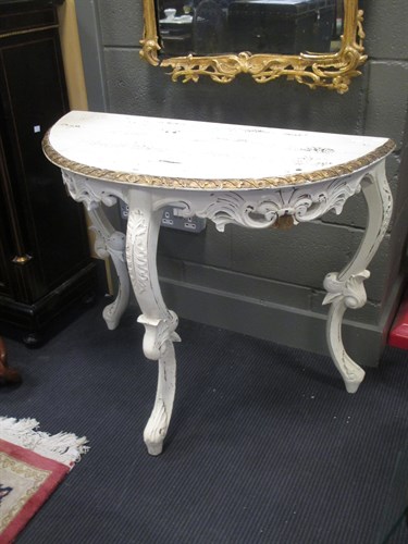 Lot 388 - A painted and gilded demi-lune console table...