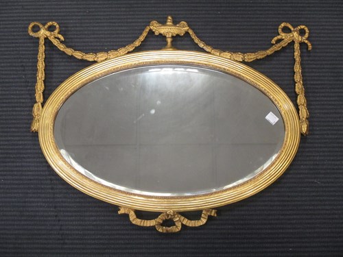 Lot 419 - A small pair of gilt wood oval mirrors