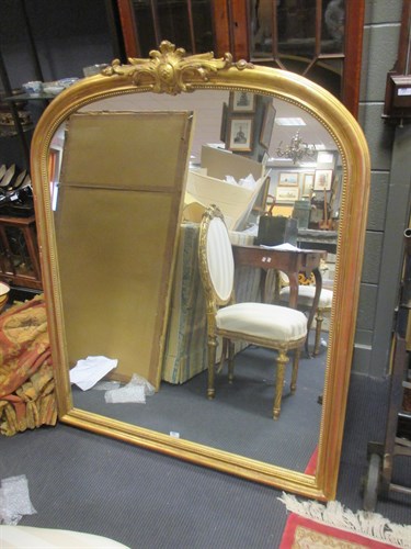 Lot 438 - A large gilt overmantle mirror
