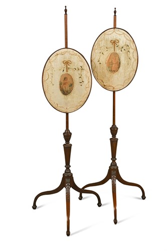 Lot 537 - A pair of George III mahogany pole screens