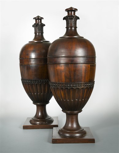 Lot 493 - A pair of modern George III style mahogany knife urns