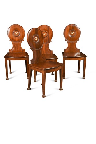 Lot 581 - A set of four George III mahogany hall chairs