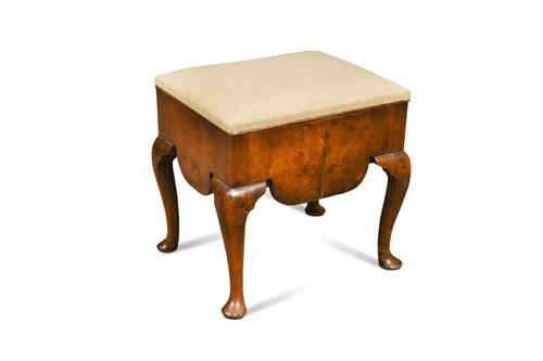 Lot 473 - An early 18th century walnut stool with shaped apron