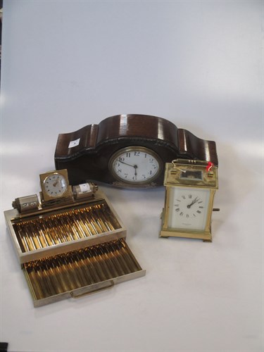 Lot 34 - A walnut mantel clock, 1922, a brass carriage...