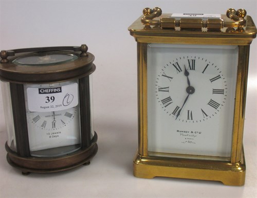 Lot 39 - A carriage clock retailed by Munsey, together...