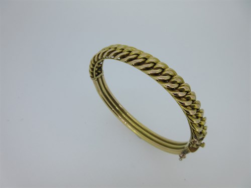 Lot 36 - A hinged bangle with fixed chain link front stamped '15'