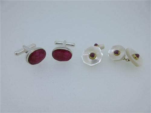 Lot 99 - A pair of single ended ruby cufflinks together with a pair of mother-of-pearl and ruby cufflinks