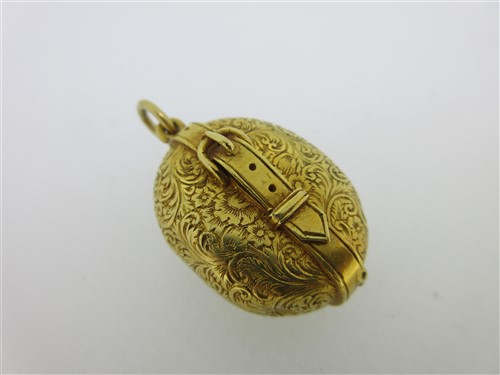 Lot 112 - A Victorian garter locket enclosing a folding double photograph frame