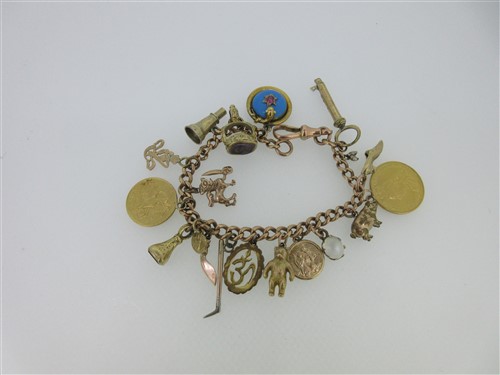 Lot 15 - A 9ct gold charm bracelet with eighteen charms