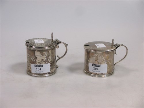 Lot 204 - Two silver mustard pots with blue glass liners...