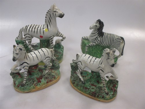 Lot 6 - A pair of Staffordshire models of zebras; two...