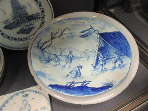 Lot 76 - A Delft polychrome plate, decorated to the...
