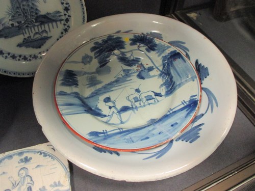 Lot 76 - A Delft polychrome plate, decorated to the...