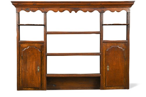 Lot 434 - A George III oak wall mounted shelf