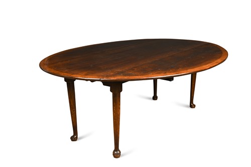 Lot 447 - A large oak crossbanded drop leaf dining table, 20th century 