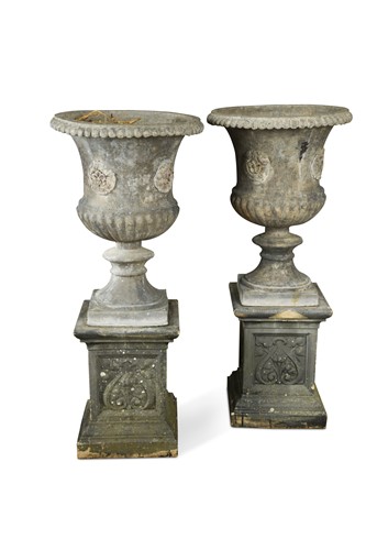 Lot 586 - A pair of lead two handled garden urns