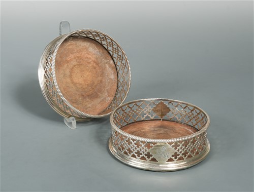 Lot 569 - A pair of George III silver bottle coasters