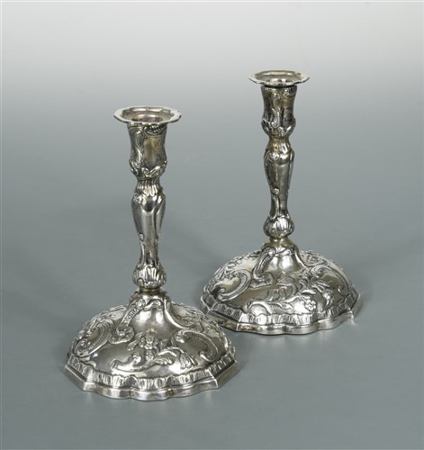 Lot 514 - A pair of cast continental metalwares candlesticks