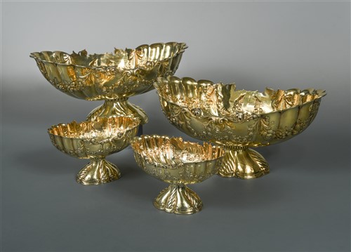 Lot 620 - A suite of four early 20th century silver gilt jardinières