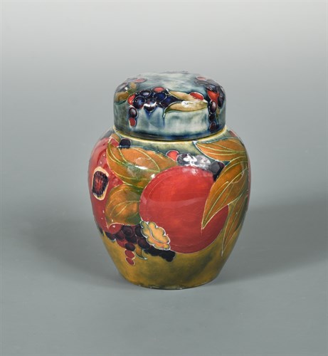 Lot 43 - A small early Moorcroft Pomegranate pattern jar and cover