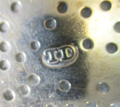Lot 572 - A George III silver lemon strainer
